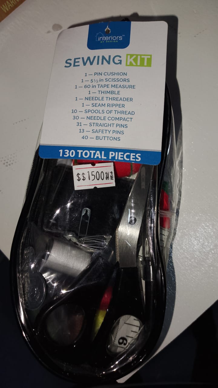 Sewing kit with scissors and thread on a white background