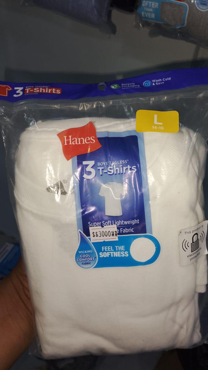 Packaged Hanes t-shirts with labels on a gray surface